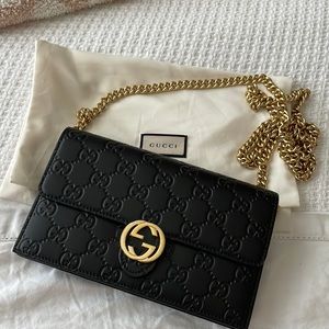 Gucci GG wallet on a chain in black gg leather.